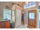 Inviting home foyer boasts tile floors, high ceilings, transom window and a decorative front door at 2700 Brienza Way, Las Vegas, NV 89117