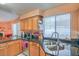 Spacious kitchen featuring granite countertops, stainless steel appliances, and wooden cabinets at 2700 Brienza Way, Las Vegas, NV 89117
