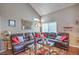 Vaulted living room with a leather sectional sofa, a decorative rug and a transom window at 2700 Brienza Way, Las Vegas, NV 89117