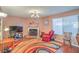 Cozy living room features a fireplace, wood floors and a large window at 2700 Brienza Way, Las Vegas, NV 89117
