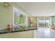 Living space with wet bar, tile flooring, sliders leading to pool, and colorful mural on wall at 2700 Brienza Way, Las Vegas, NV 89117
