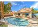 Backyard pool with outdoor seating and lush greenery, perfect for relaxation and entertaining at 2700 Brienza Way, Las Vegas, NV 89117