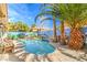 Backyard pool with palm trees, mural on the back wall, and patio seating under a sunny sky at 2700 Brienza Way, Las Vegas, NV 89117