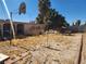 The backyard is overgrown with weeds and features multiple patio structures and a privacy wall at 2746 E Owens Ave, North Las Vegas, NV 89030