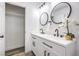 An updated bathroom offers double sinks, modern lighting, and a storage closet at 2834 Natalie Ave, Las Vegas, NV 89121