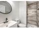 A remodeled bathroom features an updated shower with gray tiling and a modern sink at 2834 Natalie Ave, Las Vegas, NV 89121