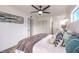 Well-lit bedroom with fan, closet, and bathroom entrance at 2834 Natalie Ave, Las Vegas, NV 89121