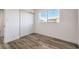A bedroom is bright with wood-look floors and a closet with sliding doors at 2834 Natalie Ave, Las Vegas, NV 89121