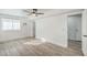 Bright bedroom featuring wood-look floors, a ceiling fan, and an ensuite bathroom with ample natural light at 2834 Natalie Ave, Las Vegas, NV 89121