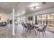 Open-concept dining area with sleek lighting, a wooden table, and access to the living room and patio at 2834 Natalie Ave, Las Vegas, NV 89121