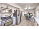 Modern kitchen with stainless steel appliances, a gas range, a view to the dining area, and hardwood floors at 2834 Natalie Ave, Las Vegas, NV 89121