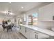Bright, open kitchen with white cabinets, countertops, and view to the living room at 2834 Natalie Ave, Las Vegas, NV 89121