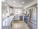 Bright, modern kitchen featuring stainless steel appliances, white cabinetry, and hardwood floors at 2834 Natalie Ave, Las Vegas, NV 89121