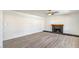 Bright living room featuring a ceiling fan, fireplace with wooden mantle, and wood-look flooring at 2834 Natalie Ave, Las Vegas, NV 89121