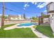 Backyard with a swimming pool, well-maintained lawn, an overhang, and block wall fence at 2834 Natalie Ave, Las Vegas, NV 89121