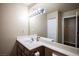 Bathroom showcasing a modern vanity, white countertop, and a large mirror at 2969 Juniper Hills Blvd # 103, Las Vegas, NV 89142