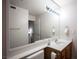 Bright bathroom featuring a large mirror, vanity with white countertop, and wood cabinetry at 2969 Juniper Hills Blvd # 103, Las Vegas, NV 89142