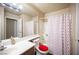 Bathroom featuring a tub-shower combo with 'XOXO' curtain and a vanity with a white countertop at 2969 Juniper Hills Blvd # 103, Las Vegas, NV 89142