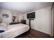 Cozy bedroom with wood floors, plush bedding, television, and natural light from the window at 2969 Juniper Hills Blvd # 103, Las Vegas, NV 89142