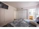 Bedroom with laminate floors, a white dresser and closet with mirror doors at 2969 Juniper Hills Blvd # 103, Las Vegas, NV 89142