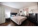 Comfortable bedroom with a mirrored dresser, soft lighting and wood-look flooring at 2969 Juniper Hills Blvd # 103, Las Vegas, NV 89142