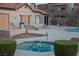 Community hot tub and pool area with well-maintained landscaping and tiled roofs at 2969 Juniper Hills Blvd # 103, Las Vegas, NV 89142