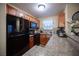 Compact kitchen boasts granite countertops, wooden cabinetry and modern appliances at 2969 Juniper Hills Blvd # 103, Las Vegas, NV 89142