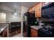Kitchen area showcasing wooden cabinets, granite countertops and black appliances at 2969 Juniper Hills Blvd # 103, Las Vegas, NV 89142