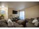 Comfortable living room featuring contemporary furnishings, a large TV, and hardwood floors at 2969 Juniper Hills Blvd # 103, Las Vegas, NV 89142