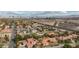 View of a red-tiled roof property, a highway, and a skyline in the distance in Las Vegas, Nevada at 3236 Cliff Sieler Ct, Las Vegas, NV 89117