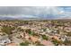A vibrant neighborhood with palm trees, red roofs, and a scenic mountain range in the background at 3236 Cliff Sieler Ct, Las Vegas, NV 89117