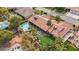 A vibrant backyard with a pool, spa, lounge area, lush foliage and desert landscaping from an aerial view at 3236 Cliff Sieler Ct, Las Vegas, NV 89117