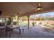 Inviting covered patio with ceiling fans, dining set, and desert landscaping at 3236 Cliff Sieler Ct, Las Vegas, NV 89117