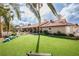 Sprawling backyard with mature landscaping and synthetic lawn at 3236 Cliff Sieler Ct, Las Vegas, NV 89117