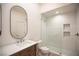 Bathroom features a shower with subway tile, and a single vanity with a framed oval mirror at 3236 Cliff Sieler Ct, Las Vegas, NV 89117