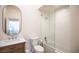 Bright bathroom features a tub with white subway tile and a modern vanity with an oval mirror at 3236 Cliff Sieler Ct, Las Vegas, NV 89117