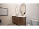 Bathroom with double vanity, framed art, and framed oval mirrors at 3236 Cliff Sieler Ct, Las Vegas, NV 89117