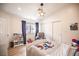 Well-lit bedroom with a white bed frame, wood laminate floors, and a large window with a view at 3236 Cliff Sieler Ct, Las Vegas, NV 89117