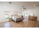 Large bedroom with wood flooring, ceiling fan, and natural light at 3236 Cliff Sieler Ct, Las Vegas, NV 89117