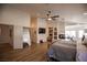 Open layout bedroom with fireplace, exercise equipment, and wood floors at 3236 Cliff Sieler Ct, Las Vegas, NV 89117