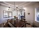 Dining room shows a dark wood table with an elaborate lighting fixture overhead at 3236 Cliff Sieler Ct, Las Vegas, NV 89117