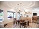Bright dining room with decorative chandelier and plenty of natural light and backyard views at 3236 Cliff Sieler Ct, Las Vegas, NV 89117