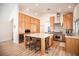 Bright modern kitchen featuring an island, wood cabinets, stainless steel appliances, and white marble countertops at 3236 Cliff Sieler Ct, Las Vegas, NV 89117
