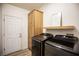 Convenient laundry room with modern washer and dryer, built-in storage, and wood-look flooring at 3236 Cliff Sieler Ct, Las Vegas, NV 89117