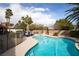 Stunning backyard pool and spa area with lush landscaping, lounge chairs, and shade at 3236 Cliff Sieler Ct, Las Vegas, NV 89117