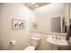 Clean and bright powder room featuring a modern sink, mirror, and tiled backsplash at 3236 Cliff Sieler Ct, Las Vegas, NV 89117