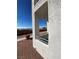 View of a balcony with a textured stucco exterior, a metal railing, and a view of the yard at 3318 N Decatur Blvd # 1056, Las Vegas, NV 89130