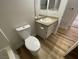 Well-lit bathroom with toilet and vanity and wood-look vinyl flooring at 3318 N Decatur Blvd # 1056, Las Vegas, NV 89130