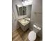This is a bathroom that has a toilet, sink, and mirror with a towel rack at 3318 N Decatur Blvd # 1056, Las Vegas, NV 89130