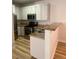 Bright kitchen offers stainless steel appliances, breakfast bar and light wood flooring at 3318 N Decatur Blvd # 1056, Las Vegas, NV 89130